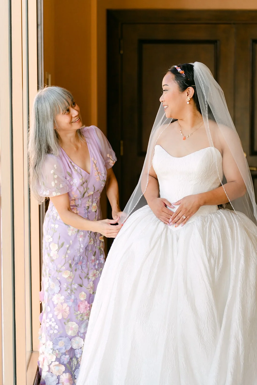Angela and her mom sharing a moment before the ceremony