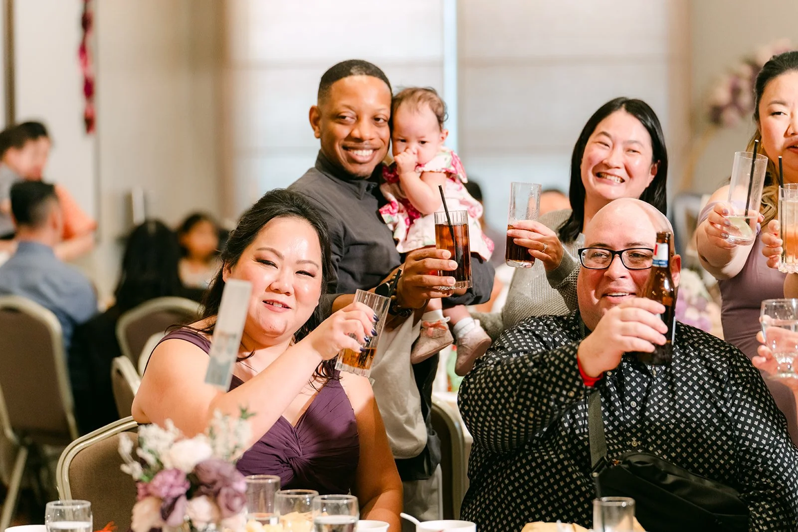 Guests raising their glasses during dinner.