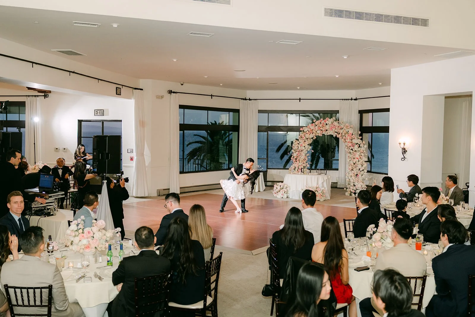 Guests watching the first dance in the reception room