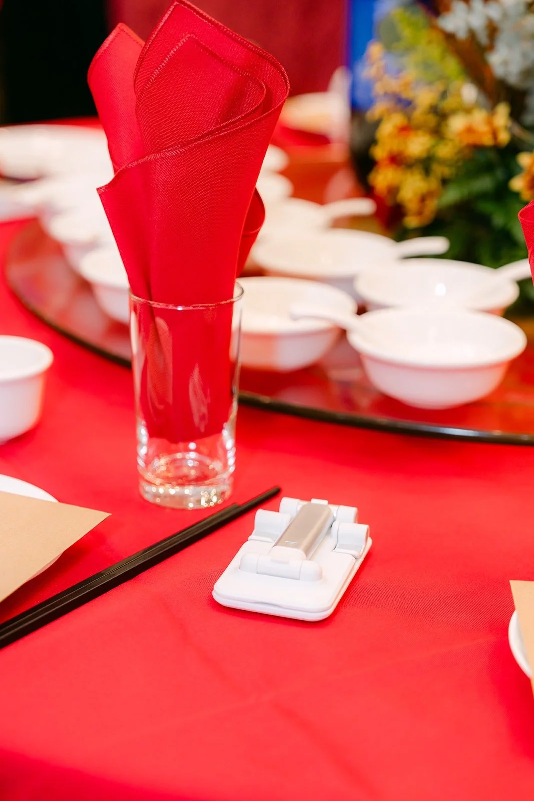 A place setting with chopsticks and a folded red napkin