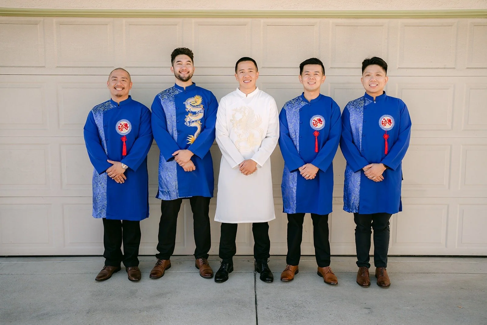 Kevin in a white ao dai with his groomsmen in royal blue ao dai