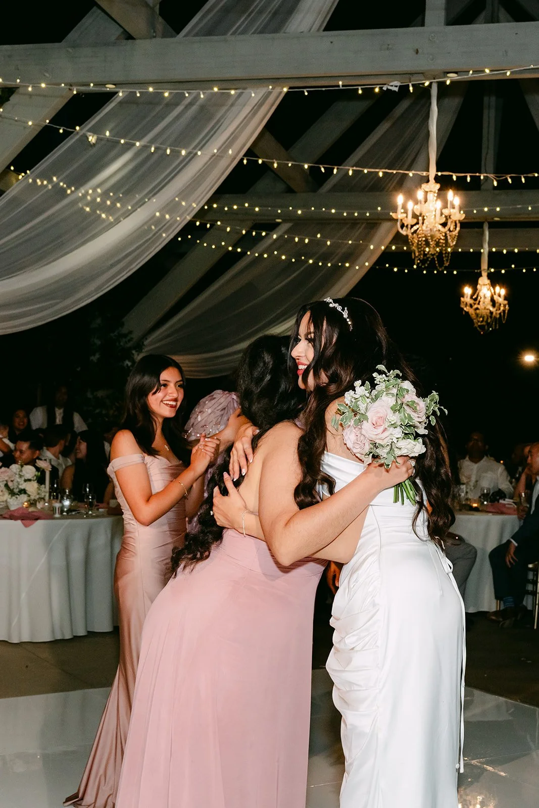 Sandra hugging the bridesmaid who caught the bouquet.
