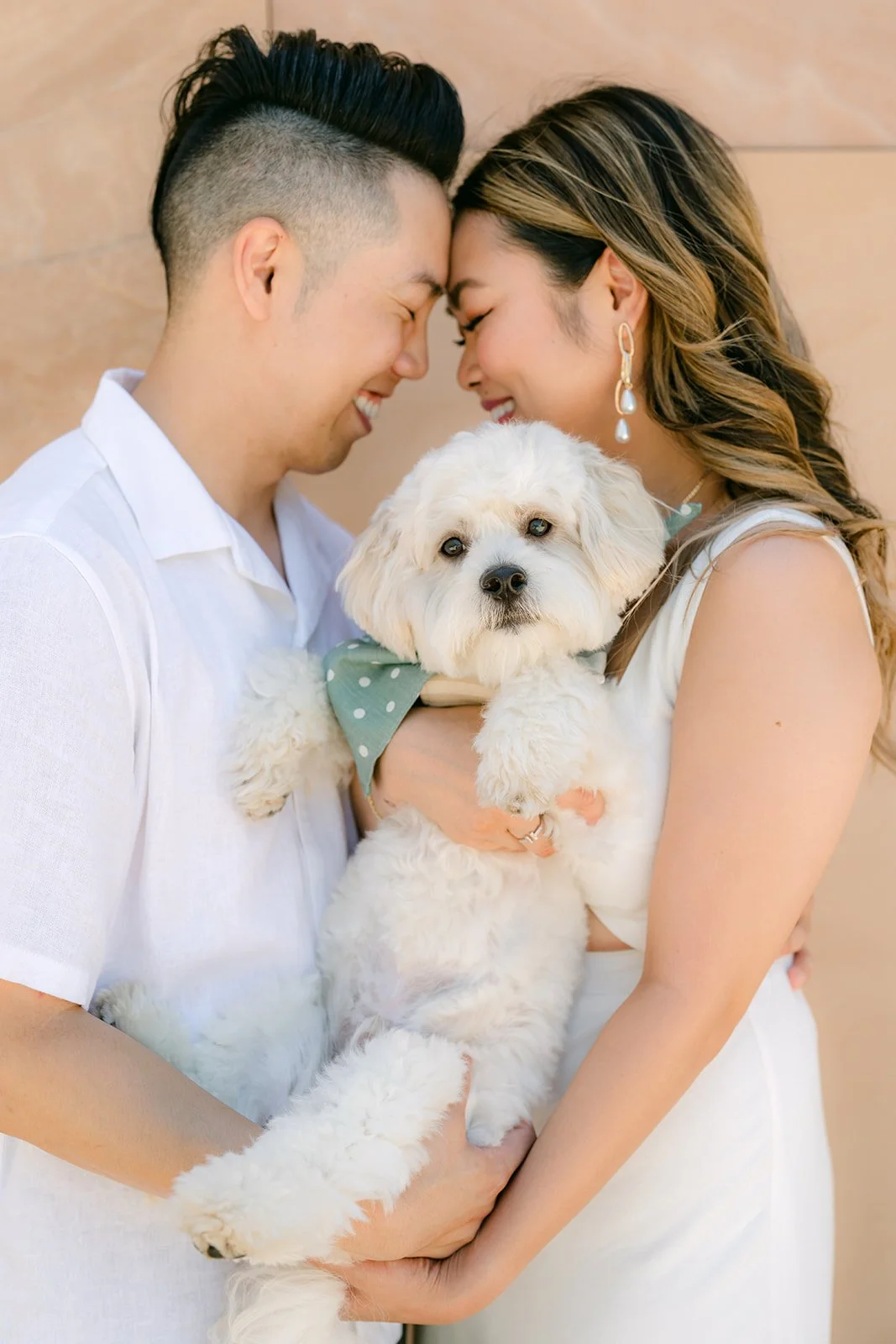 Alan and Stephanie touch foreheads while holding Tofu.