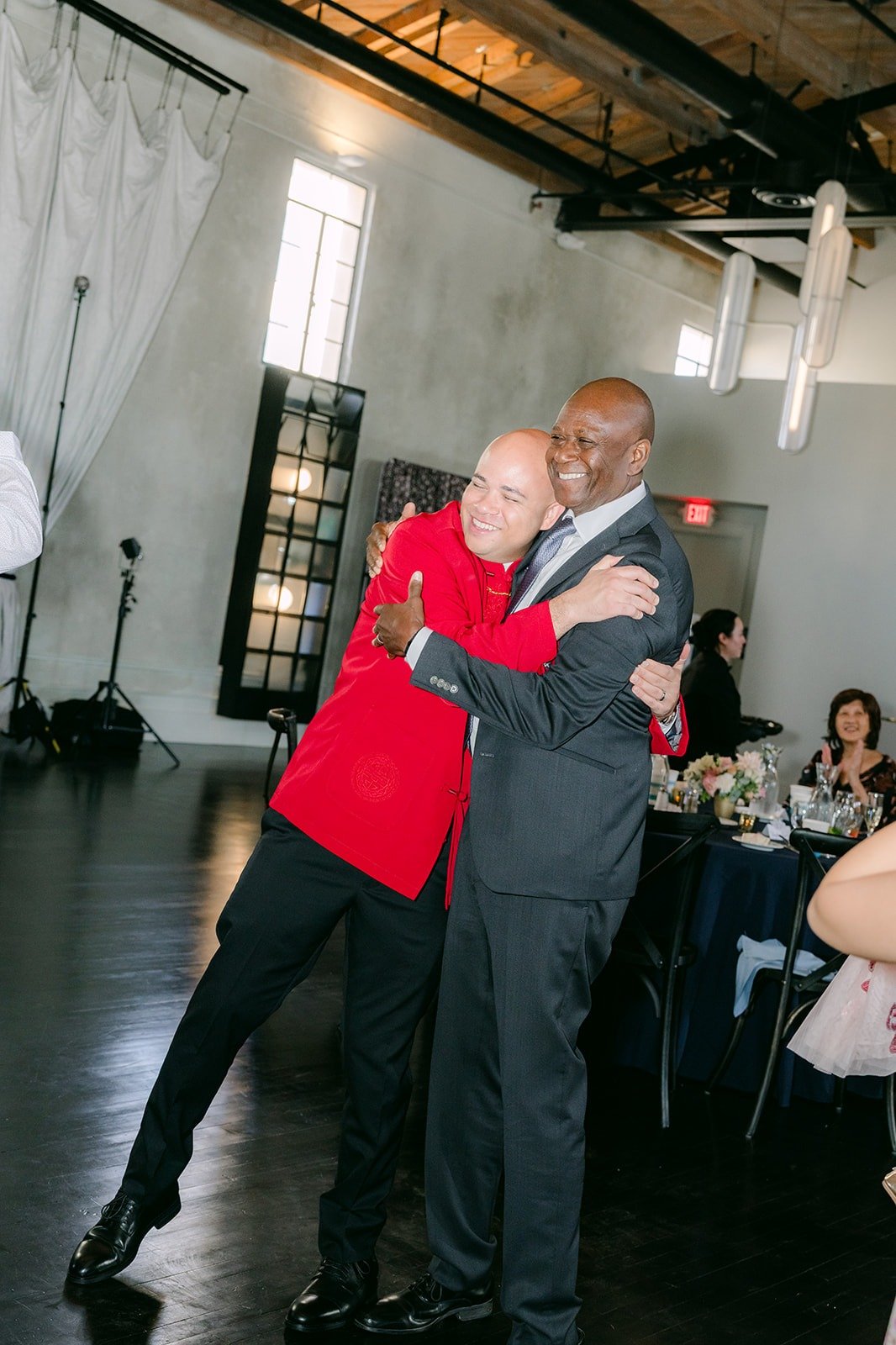 Brandon hugs a guest on the dance floor, photographed by One and Only Production