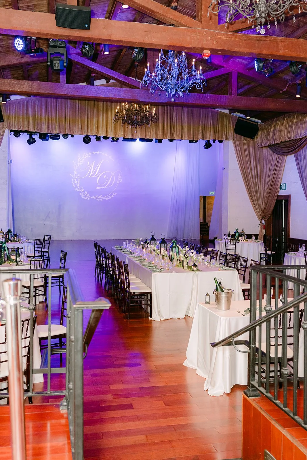 Reception room at Padua Hills Theatre lit in lavender with the long head table