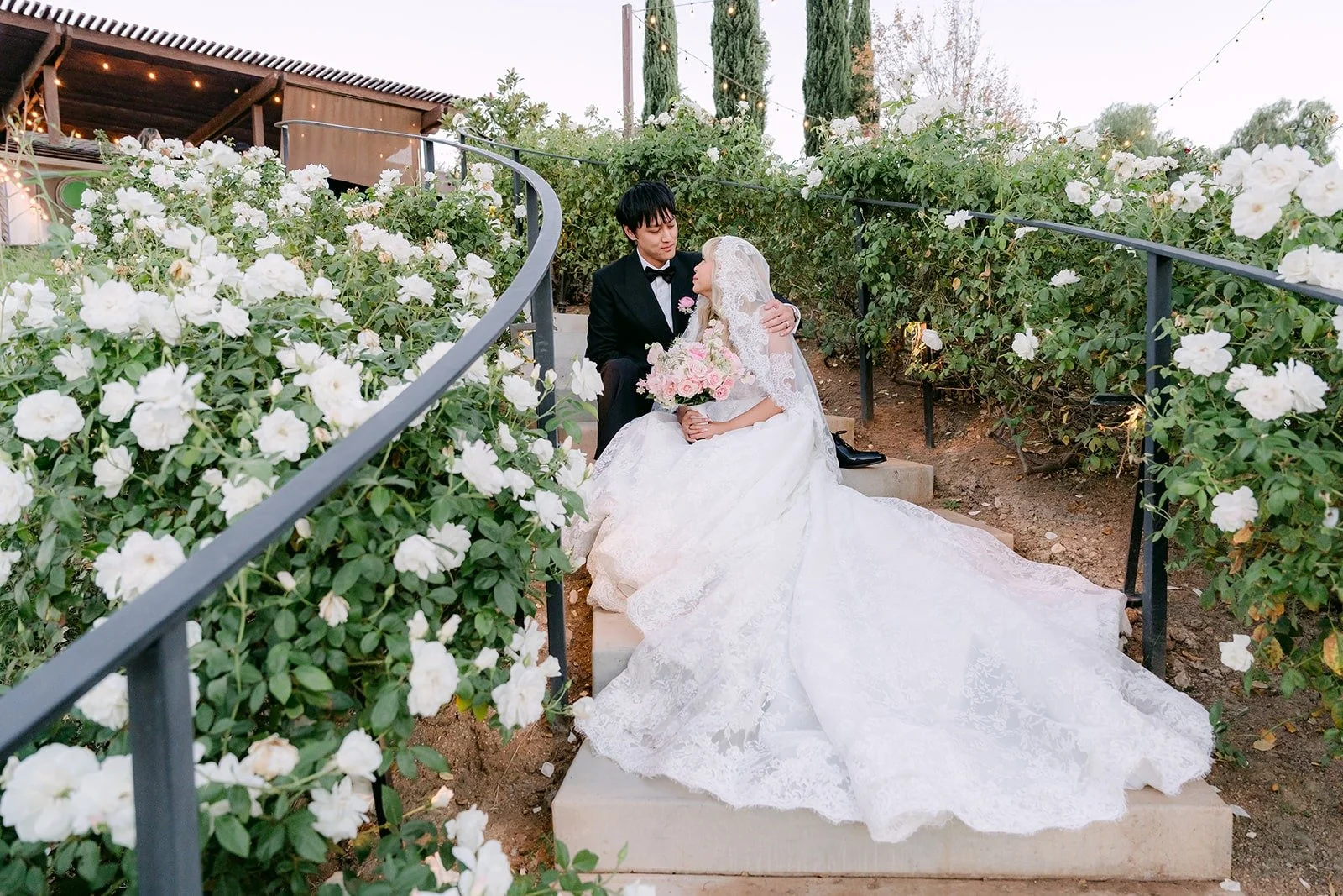 Konitha and Job on the rose covered steps, photographed by One and Only Production
