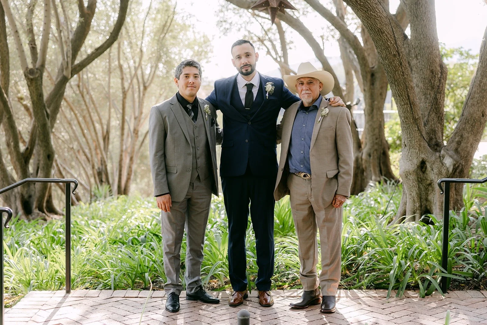 Danny with two friends outside under the trees at Padua Hills Theatre