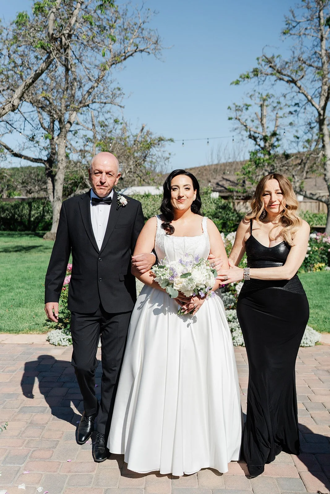 Mariam walking down the aisle with her parents