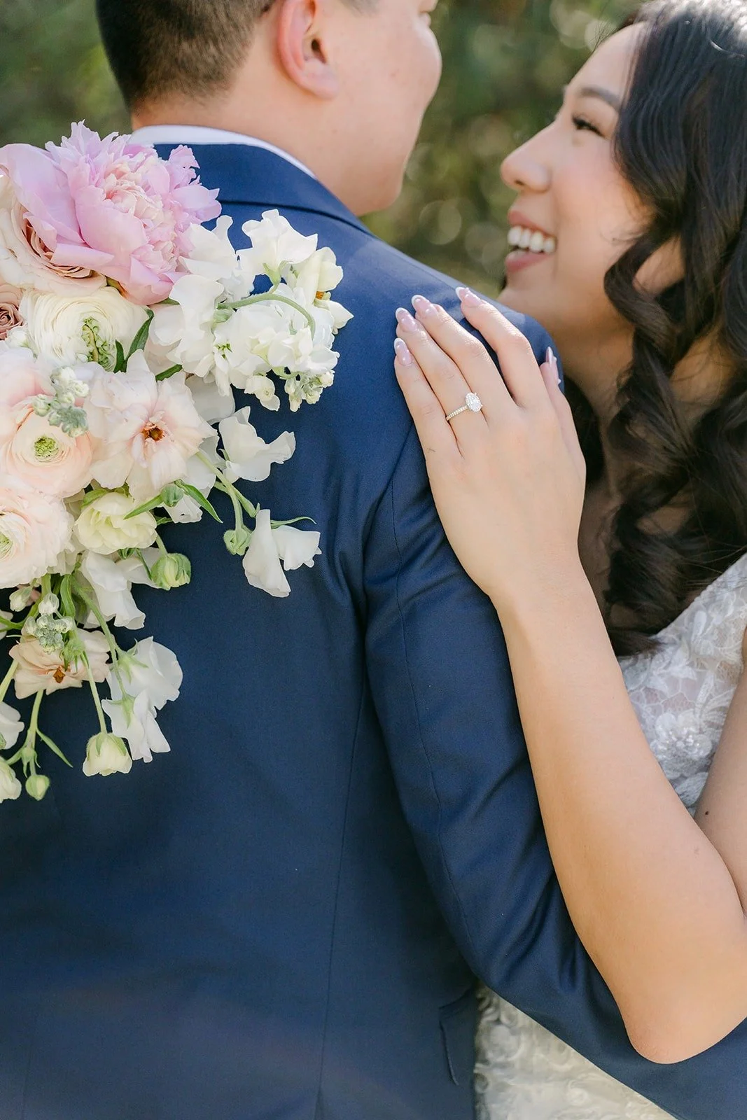 Kelli resting her hand on Alex's chest with her bouquet at his shoulder