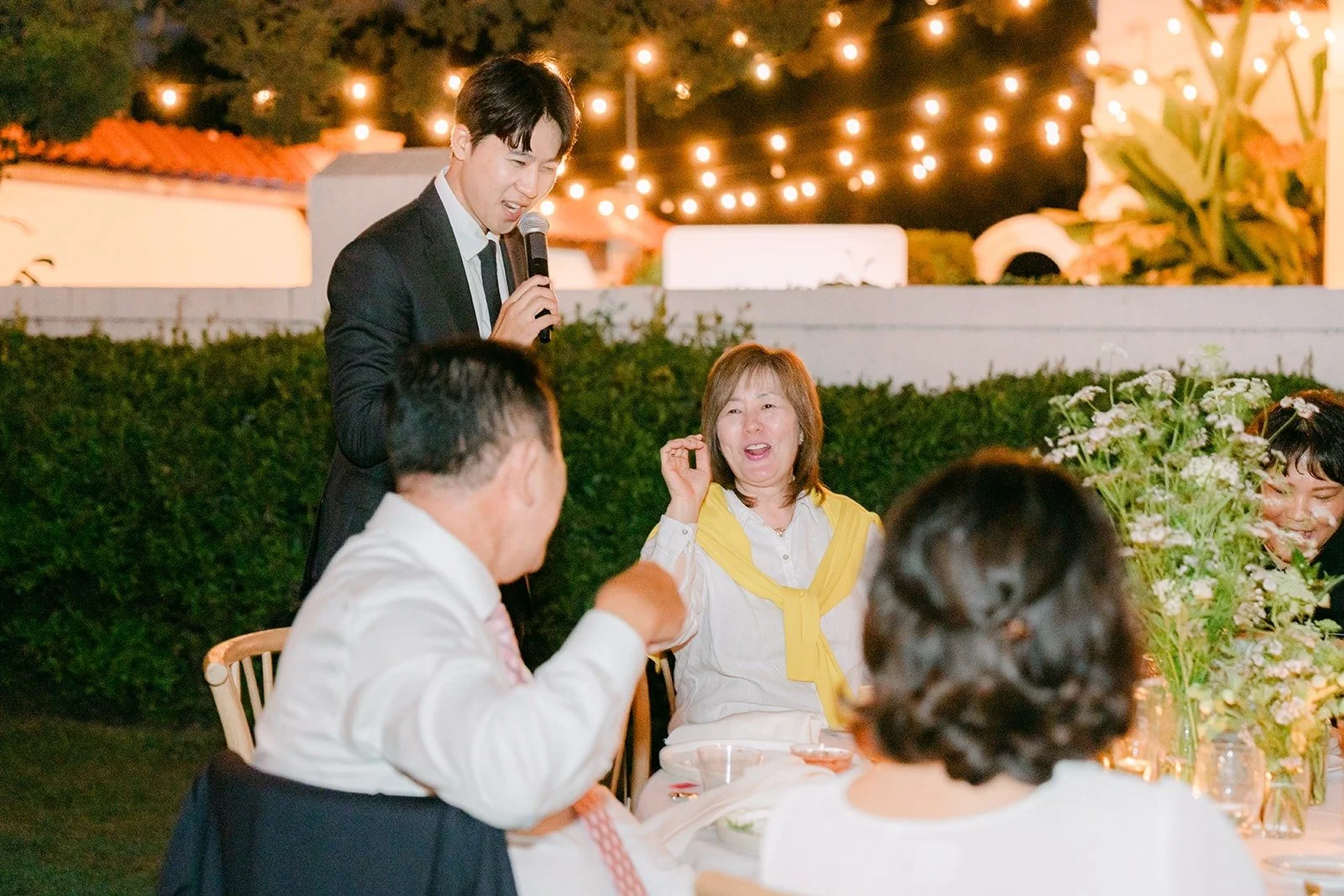 Guests cheering under the string lights during the games