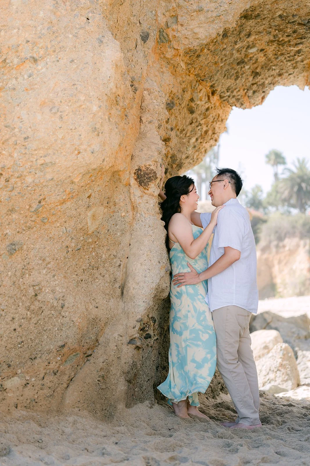 Constance and Lawrence leaning against the rock wall.