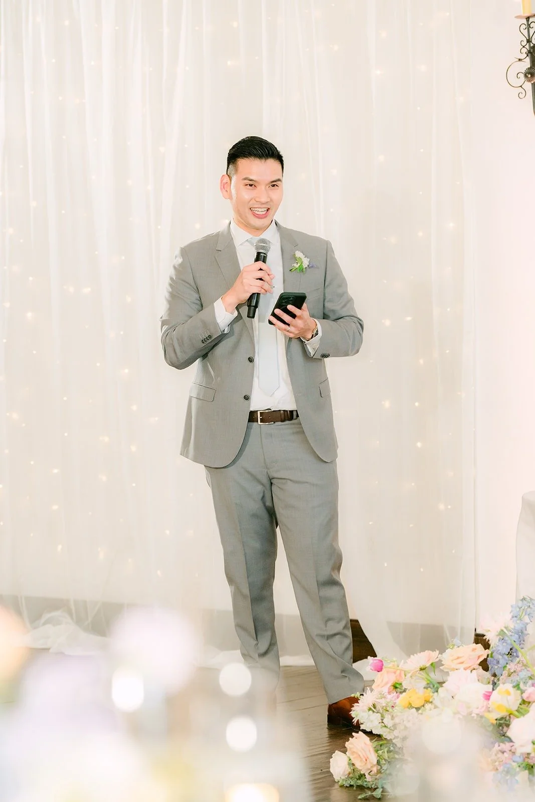 A groomsman giving a speech in the parlor