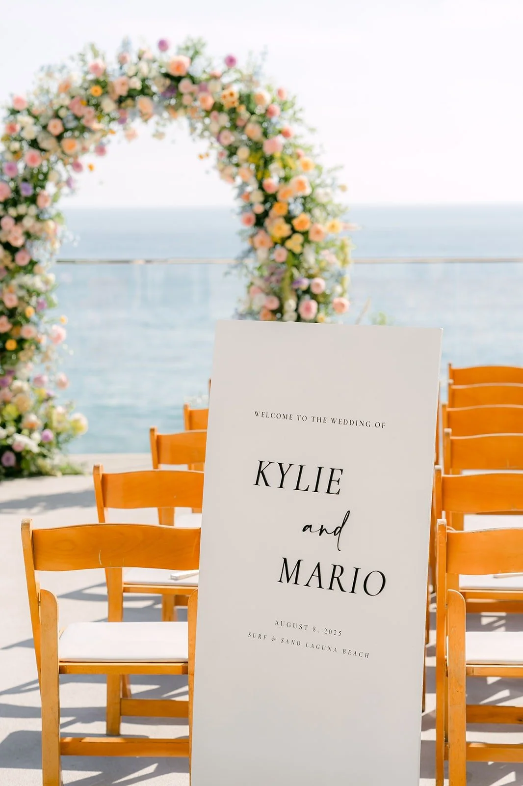 A welcome sign reading Kylie and Mario beside the aisle