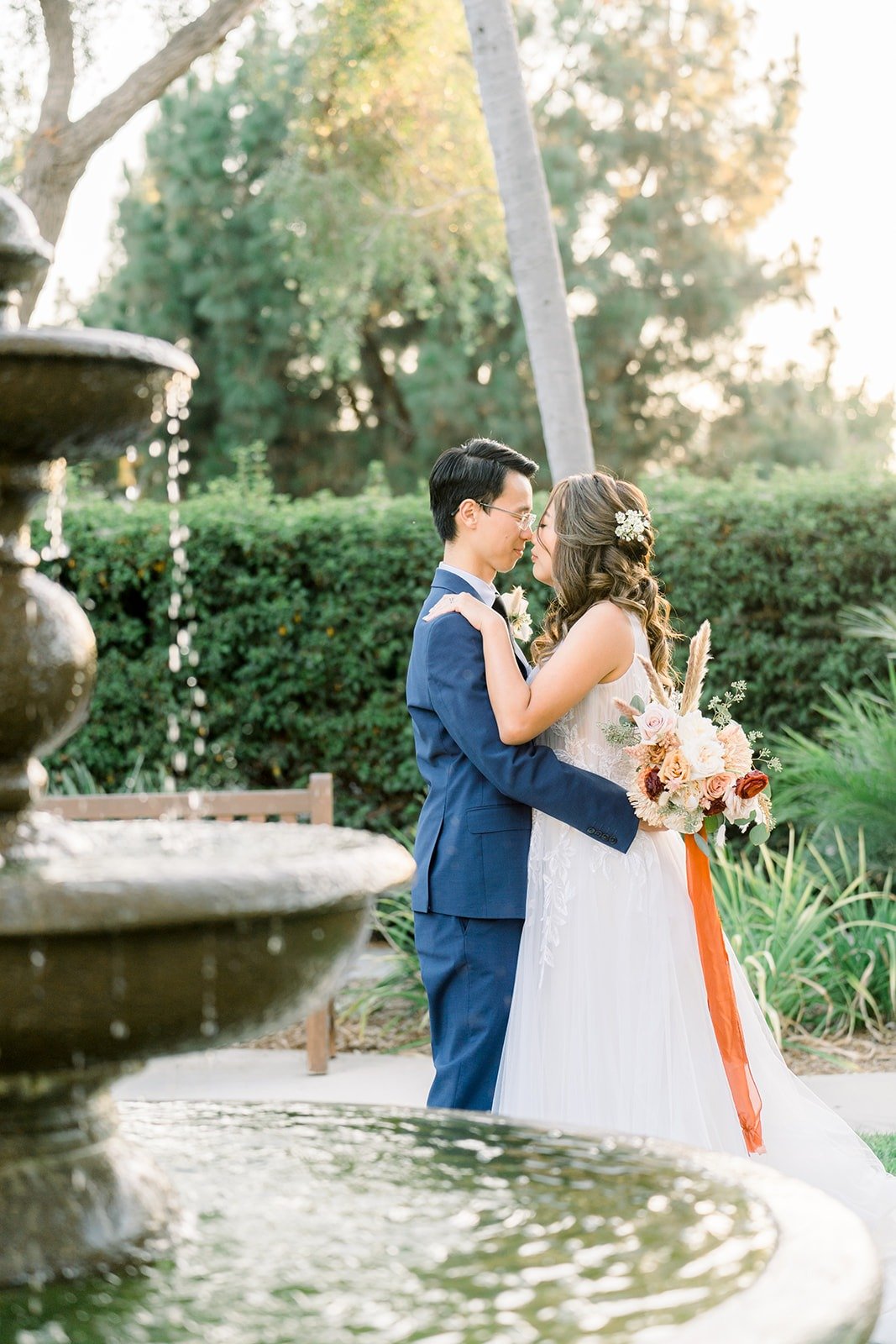 Alex holding Ariel close by the fountain