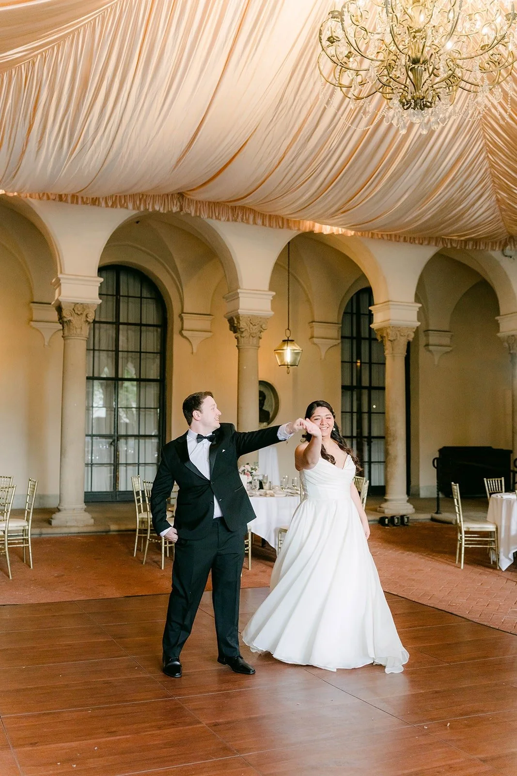 Saira and Matthew twirling in the middle of the empty room