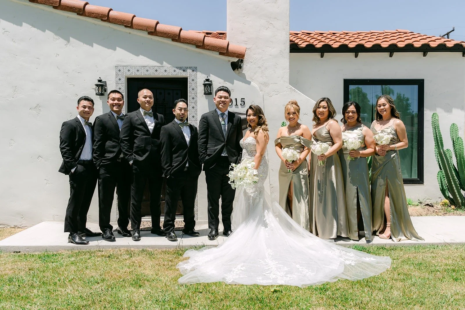 Wedding party in sage green and black outside the Airbnb in Alhambra