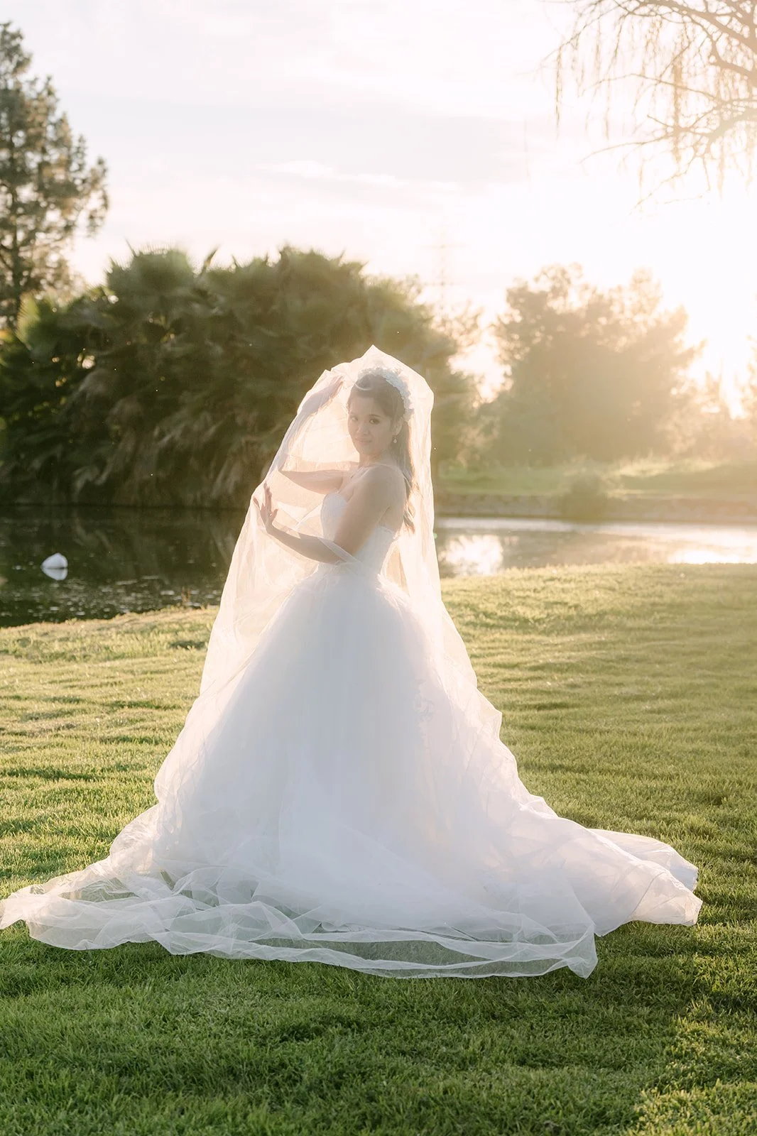Kate standing alone on the grass in her ball gown.
