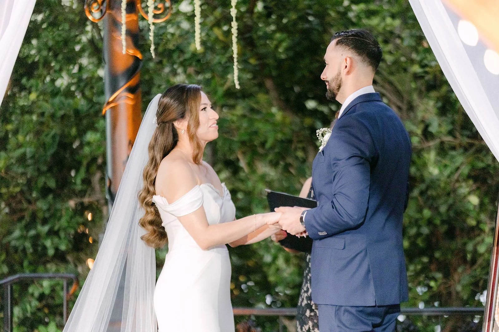 Danny reading his vows to Mariana under the gazebo