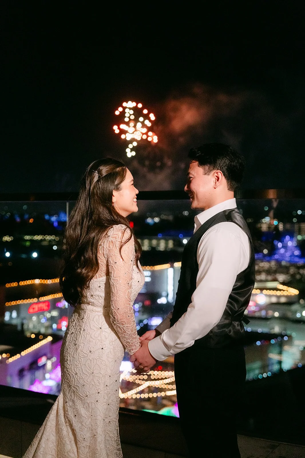 Linh and Hoan watching the Disney fireworks from a balcony at JW Marriott Anaheim