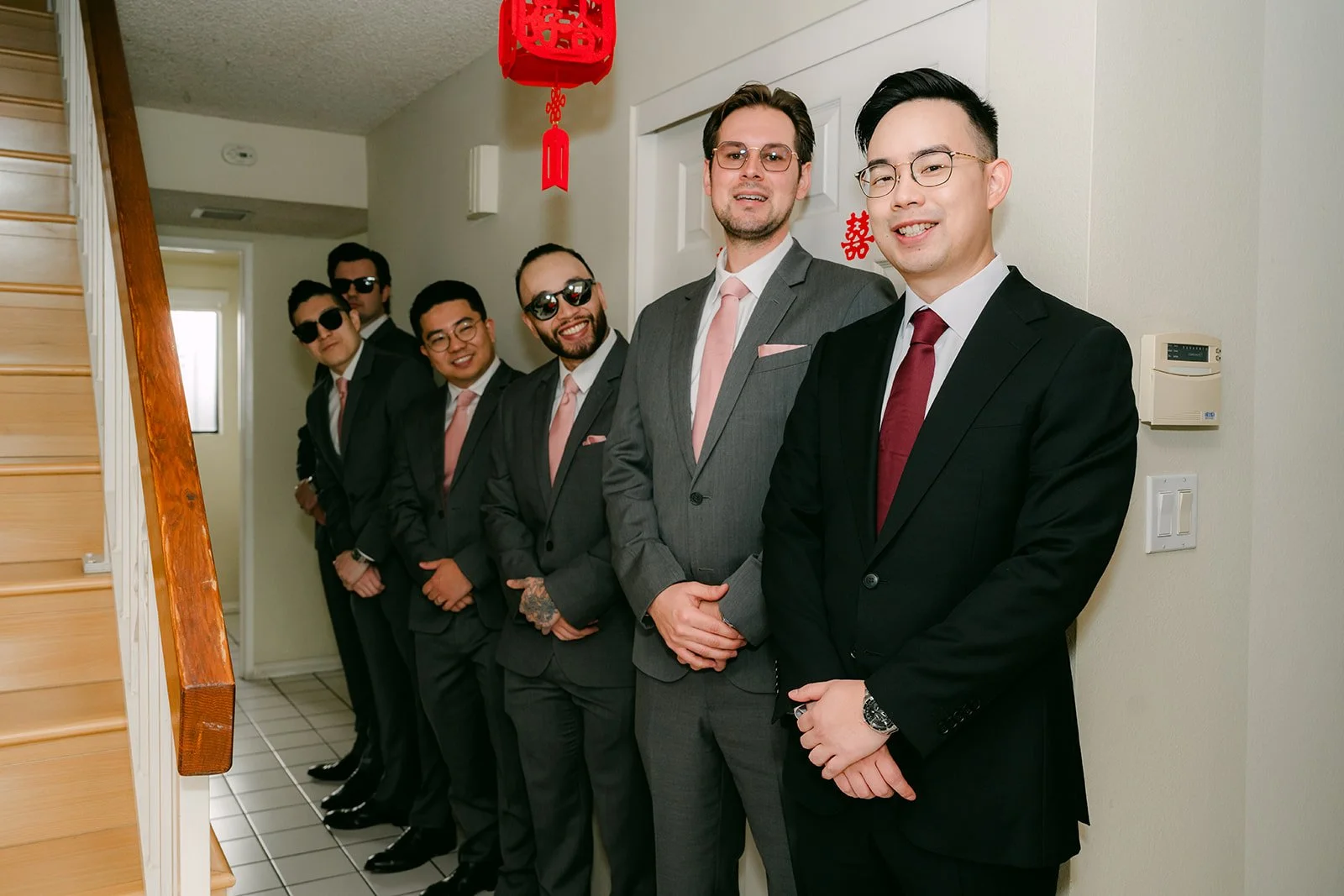 Ken and his groomsmen lined up in the hallway.