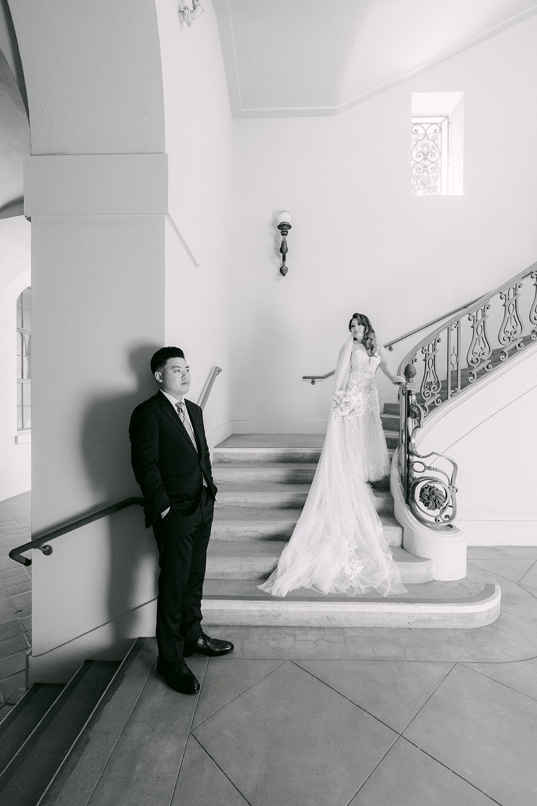 Black and white of Candice on the stairs as Vincent waits below