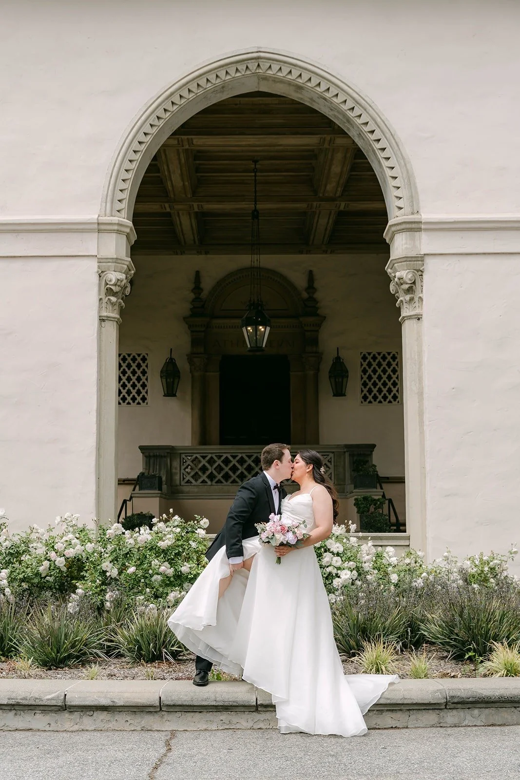 Matthew dipping in for a kiss under the carved stone archway at the entrance