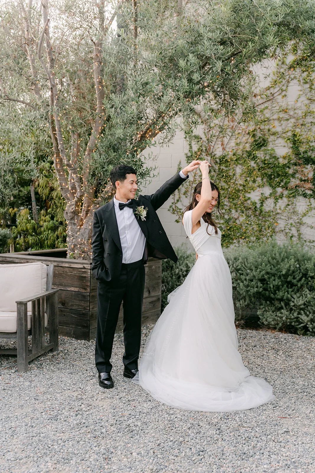 Richard twirling Jadee on the gravel path
