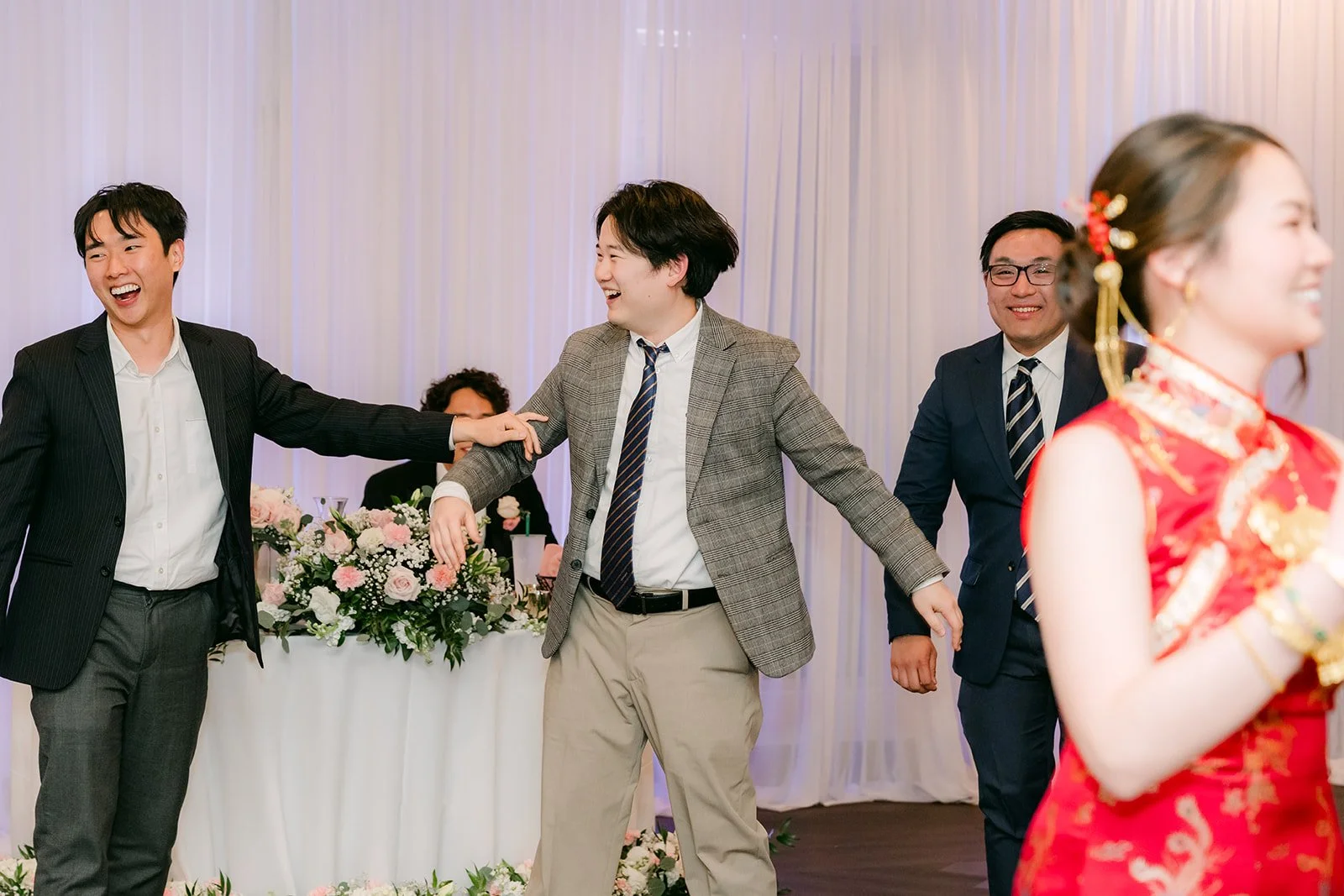 Bouquet toss moment on the reception dance floor