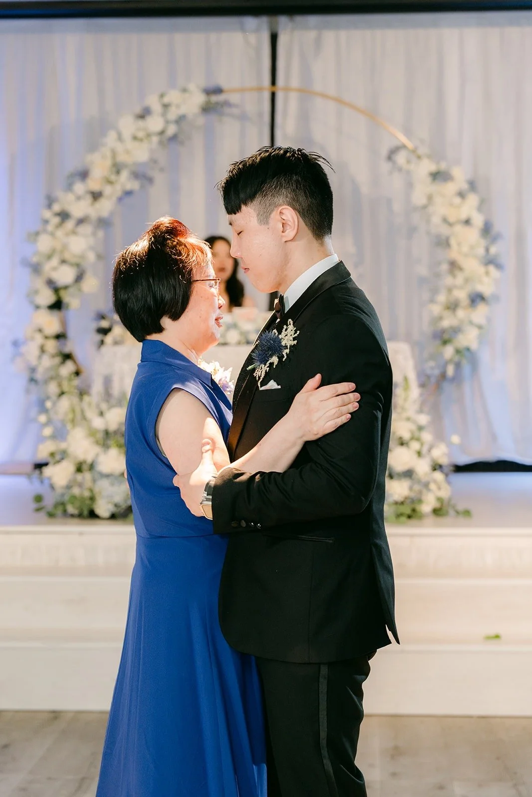 James dancing with his mom by the floral arch