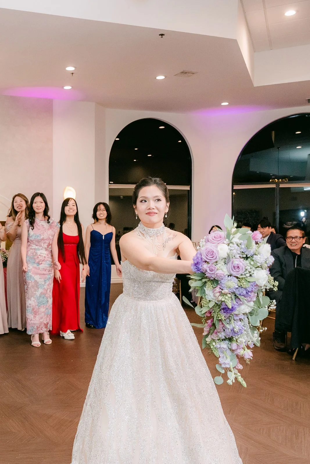 Kate tossing her bouquet to her friends.