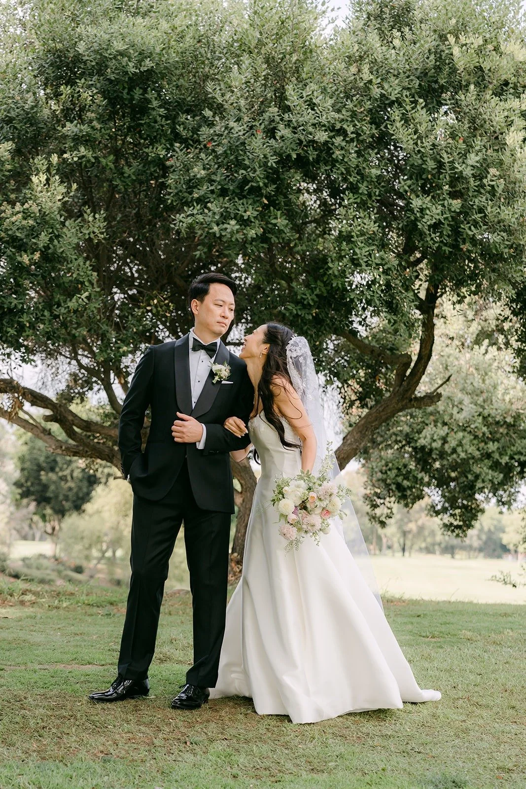 William kissing Kristine on the lawn with the golf course behind them
