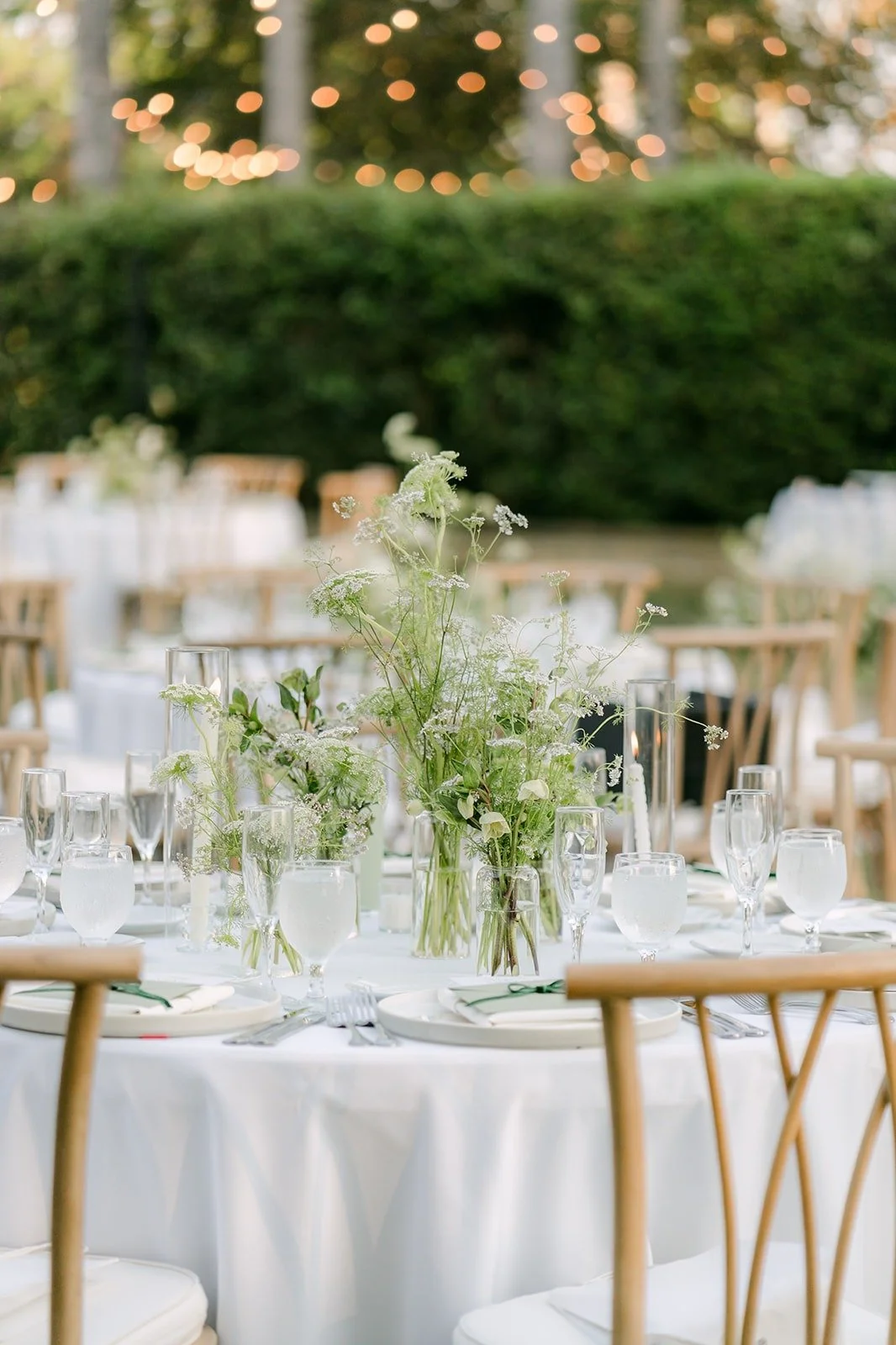 White florals and glassware on the Adella Lawn reception tables