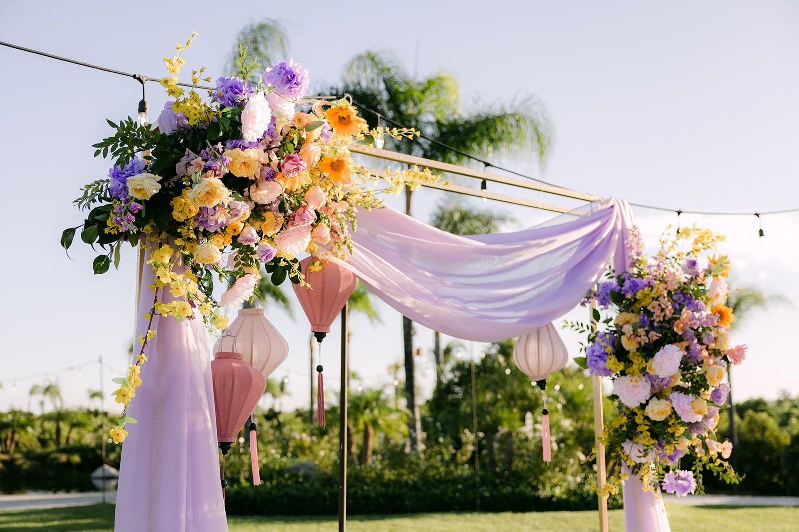 Floral arch with lilac draping at the sweetheart table.