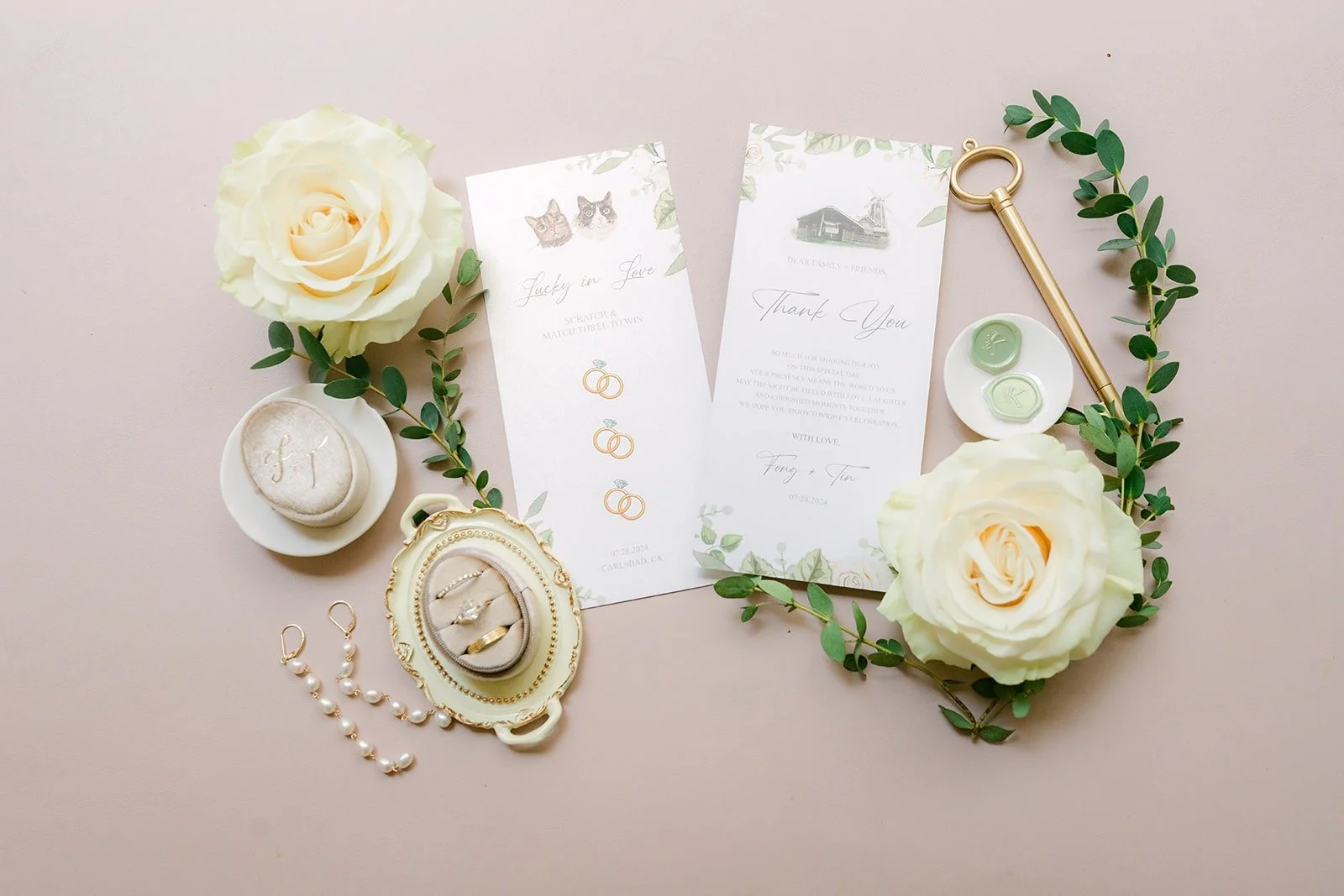 Tin and Fong's invitation suite with pearls, cream roses and a brooch at Carlsbad Windmill