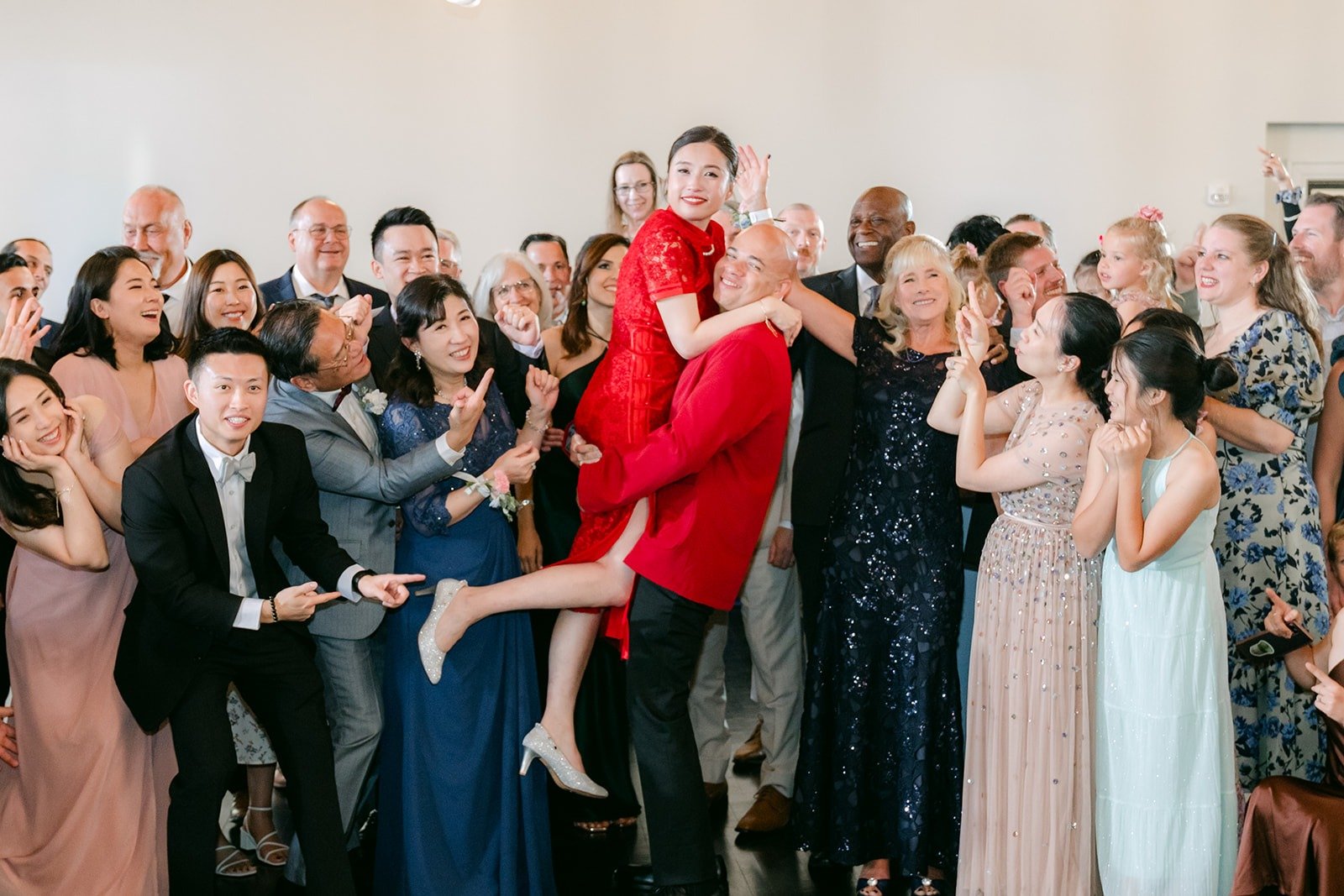 Guests cheer as Elisa is lifted on the dance floor