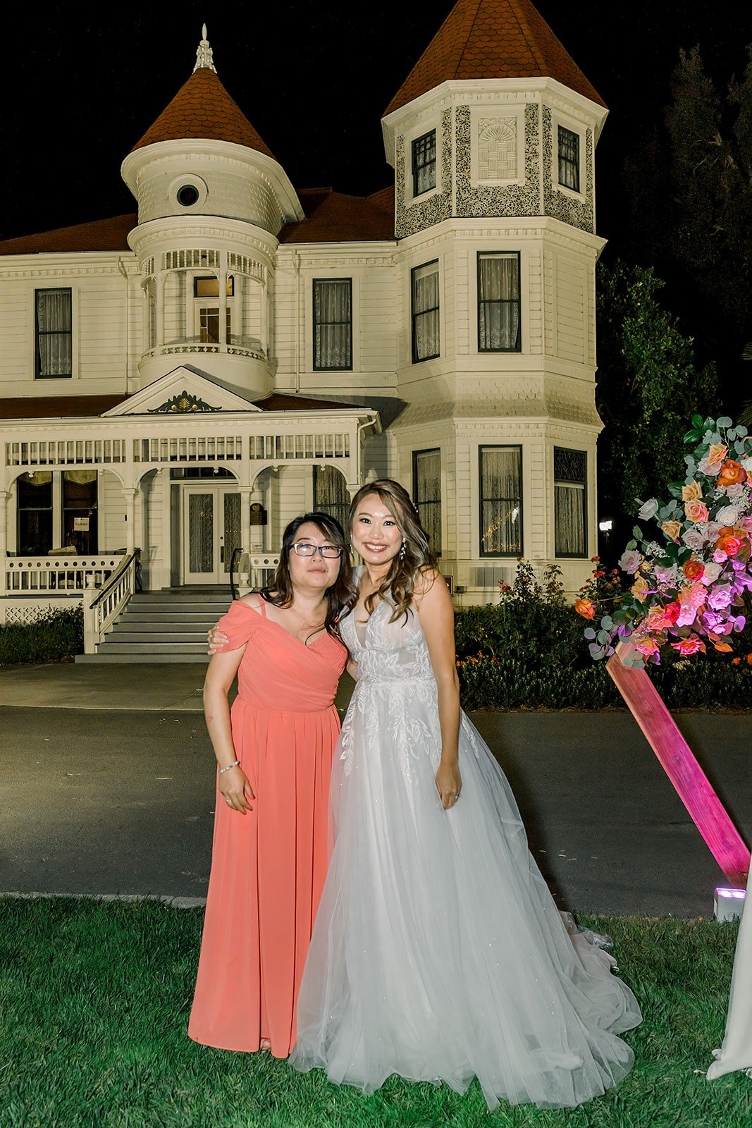 Ariel and a bridesmaid in front of the Victorian ranch house