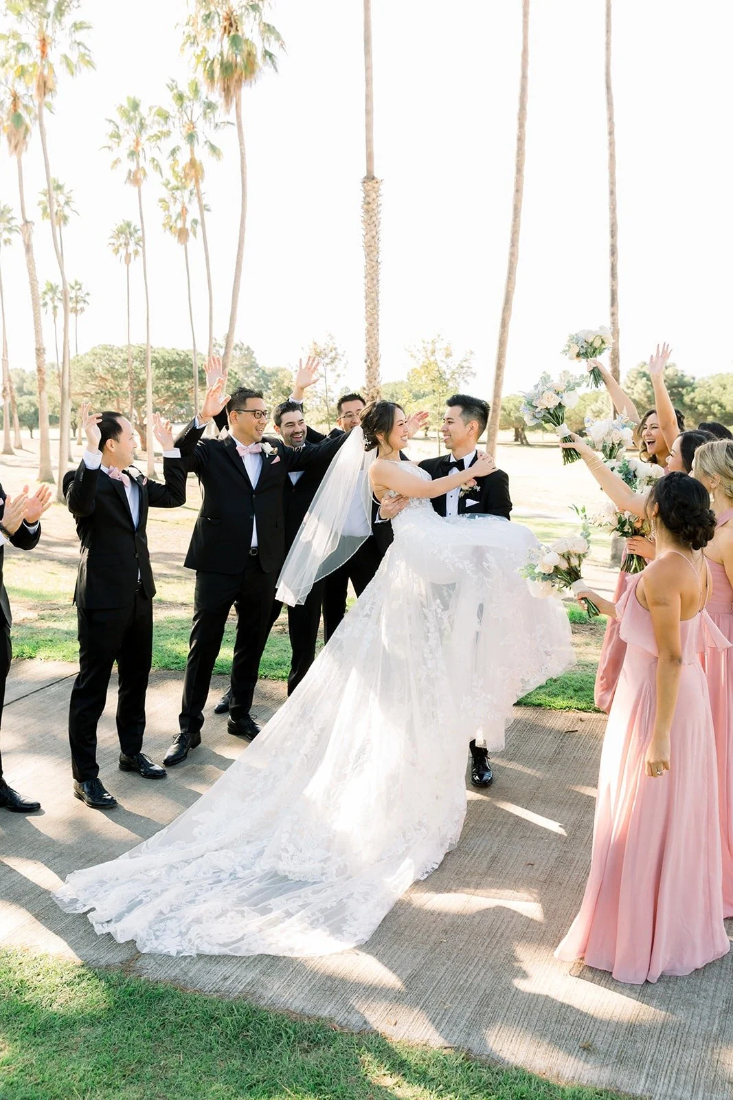 The wedding party celebrating as Josephine and David kiss, photographed by One and Only Production