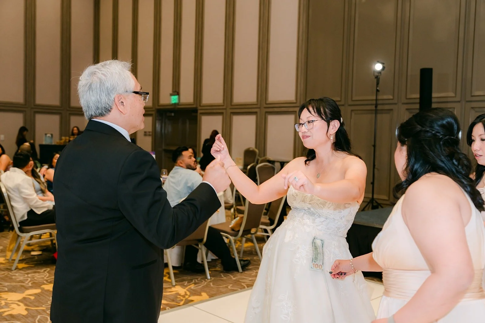 Stella dancing with a guest at the start of the money dance