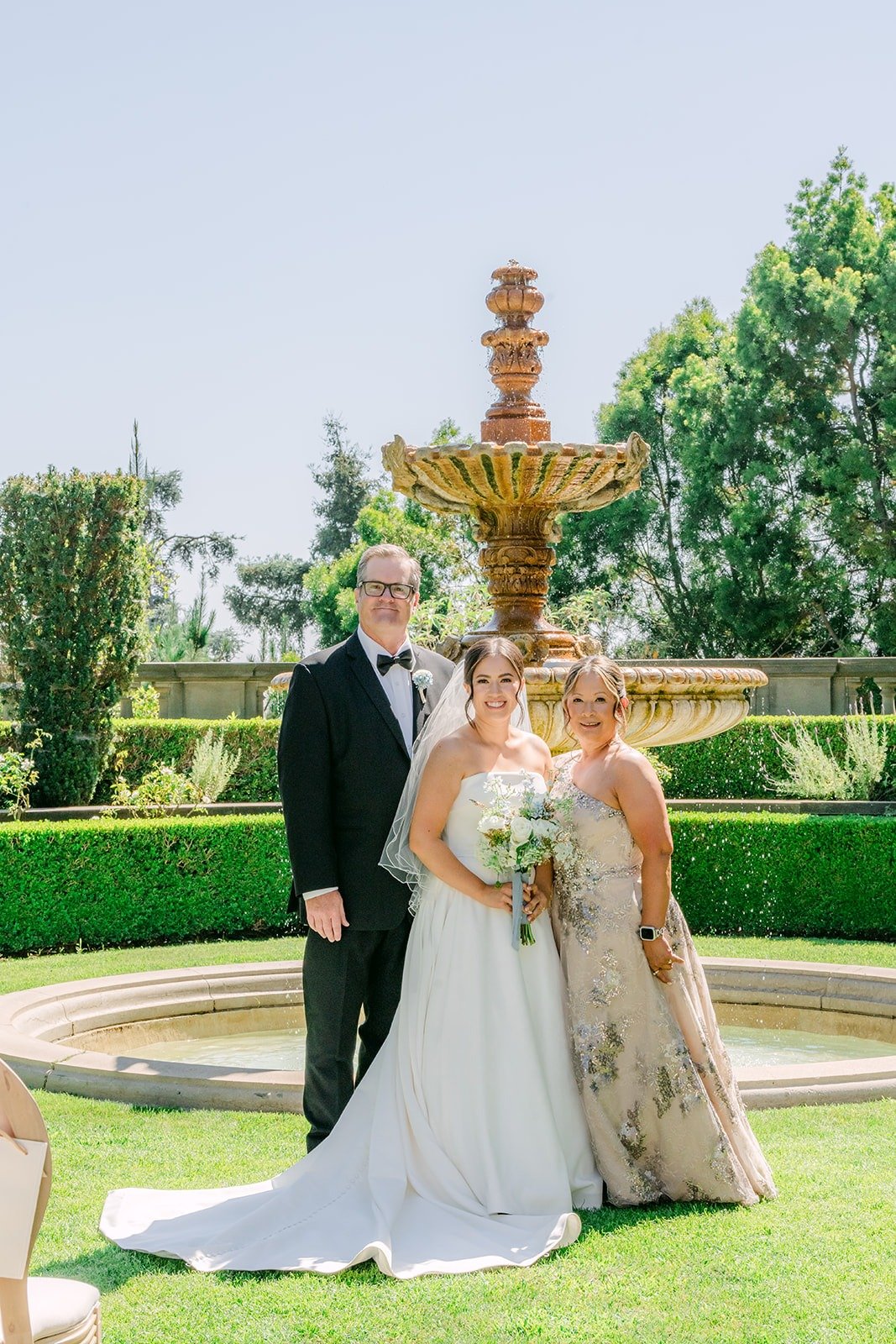 Brianna and Nik with family in front of the Greystone fountain