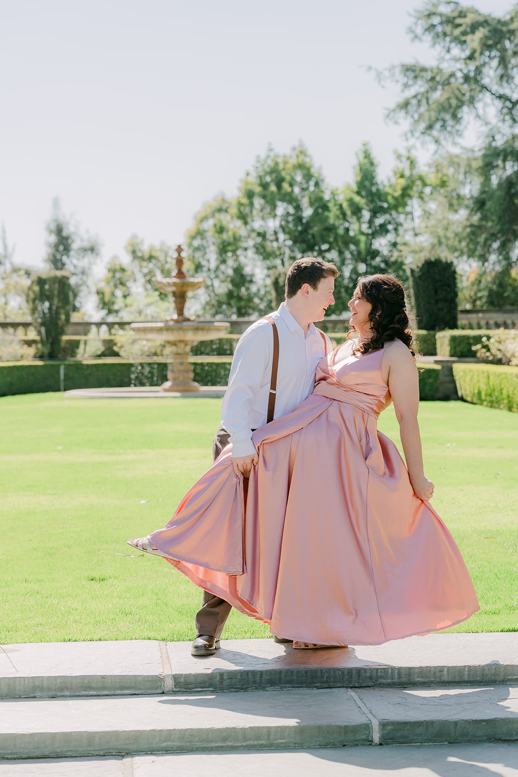 Matthew spins Saira on the lawn as her blush gown flares.