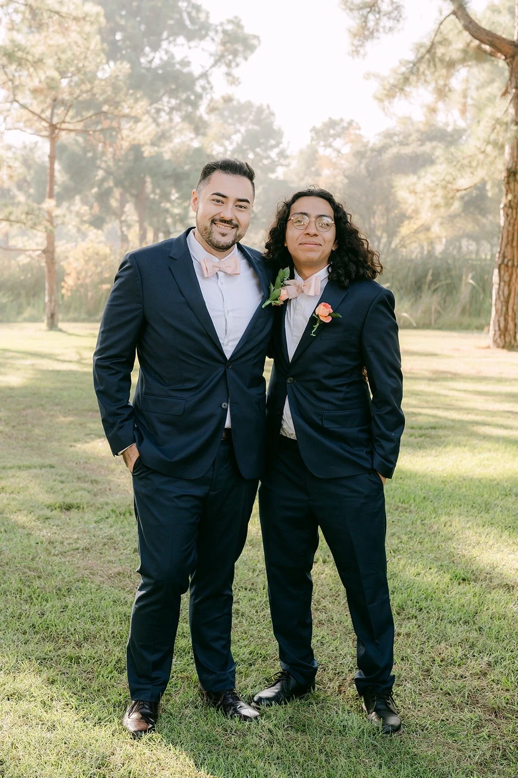 James in a navy suit with one of his crew on the lawn
