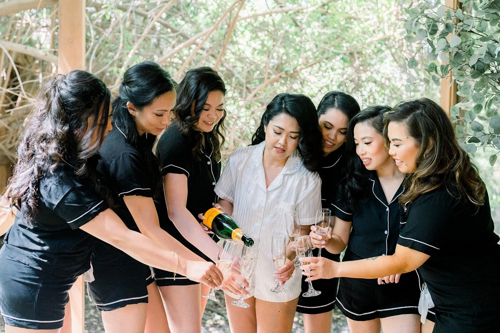 Hannah and her bridesmaids toasting before getting dressed, photographed by One and Only Production