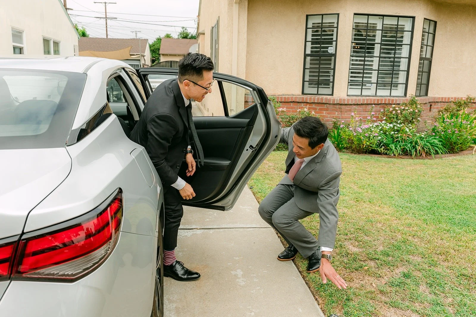 Alex opening the car door for Xuemin at his parents' house in San Gabriel