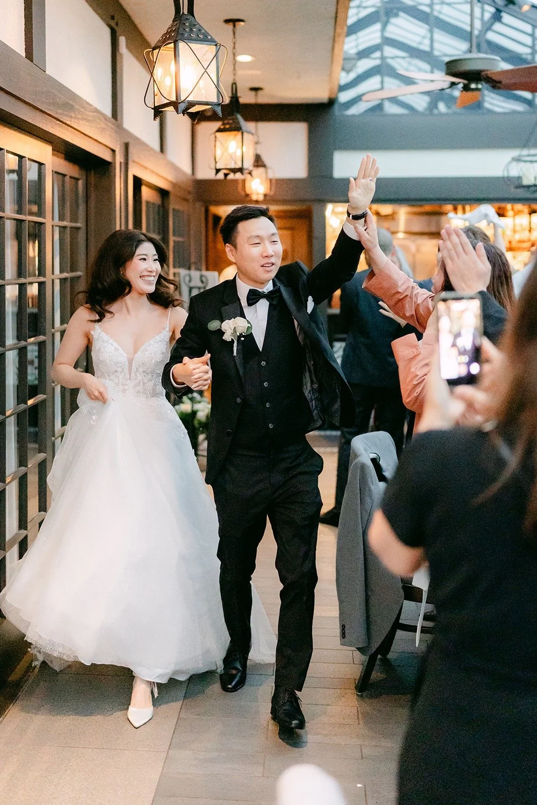 Valerie and Jason dancing into the room as guests cheer