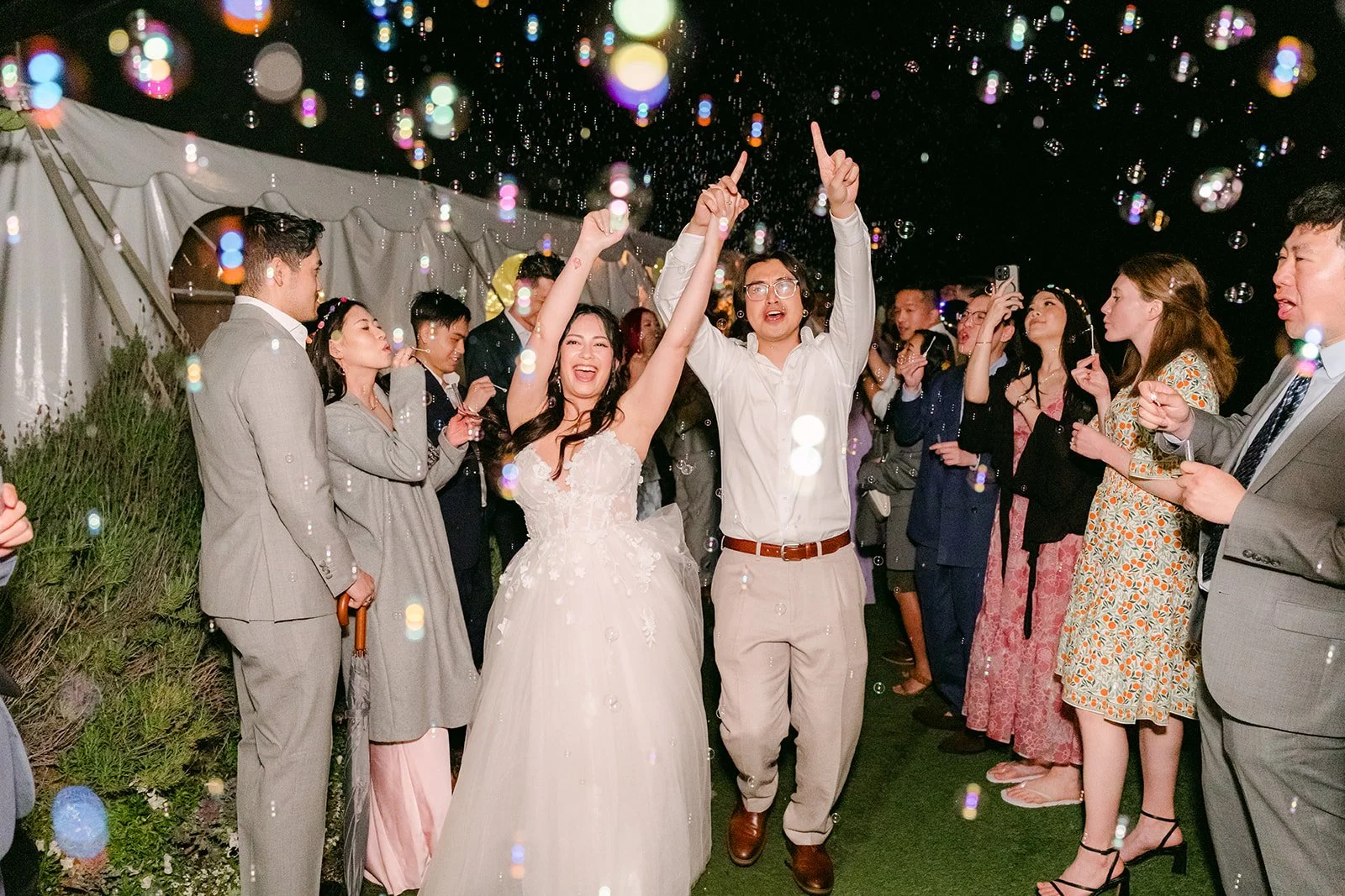 Couple laughing through a cloud of bubbles