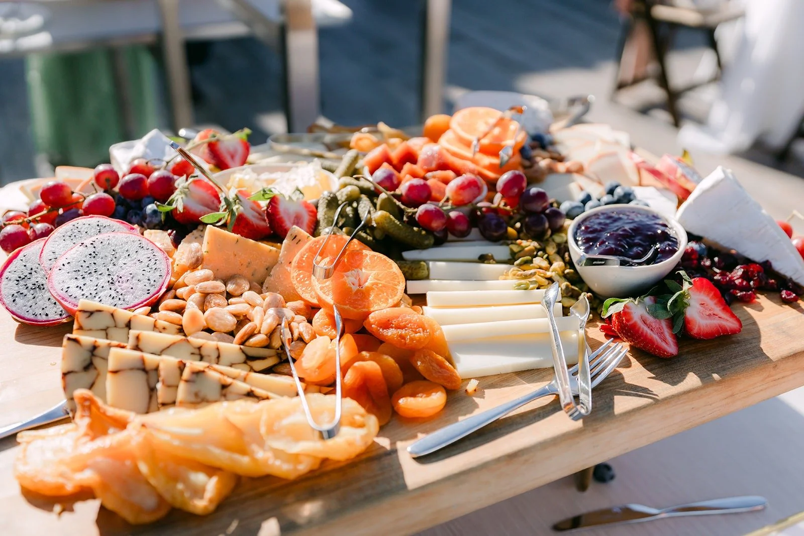 A charcuterie board loaded with fruit, cheese and pastries for cocktail hour