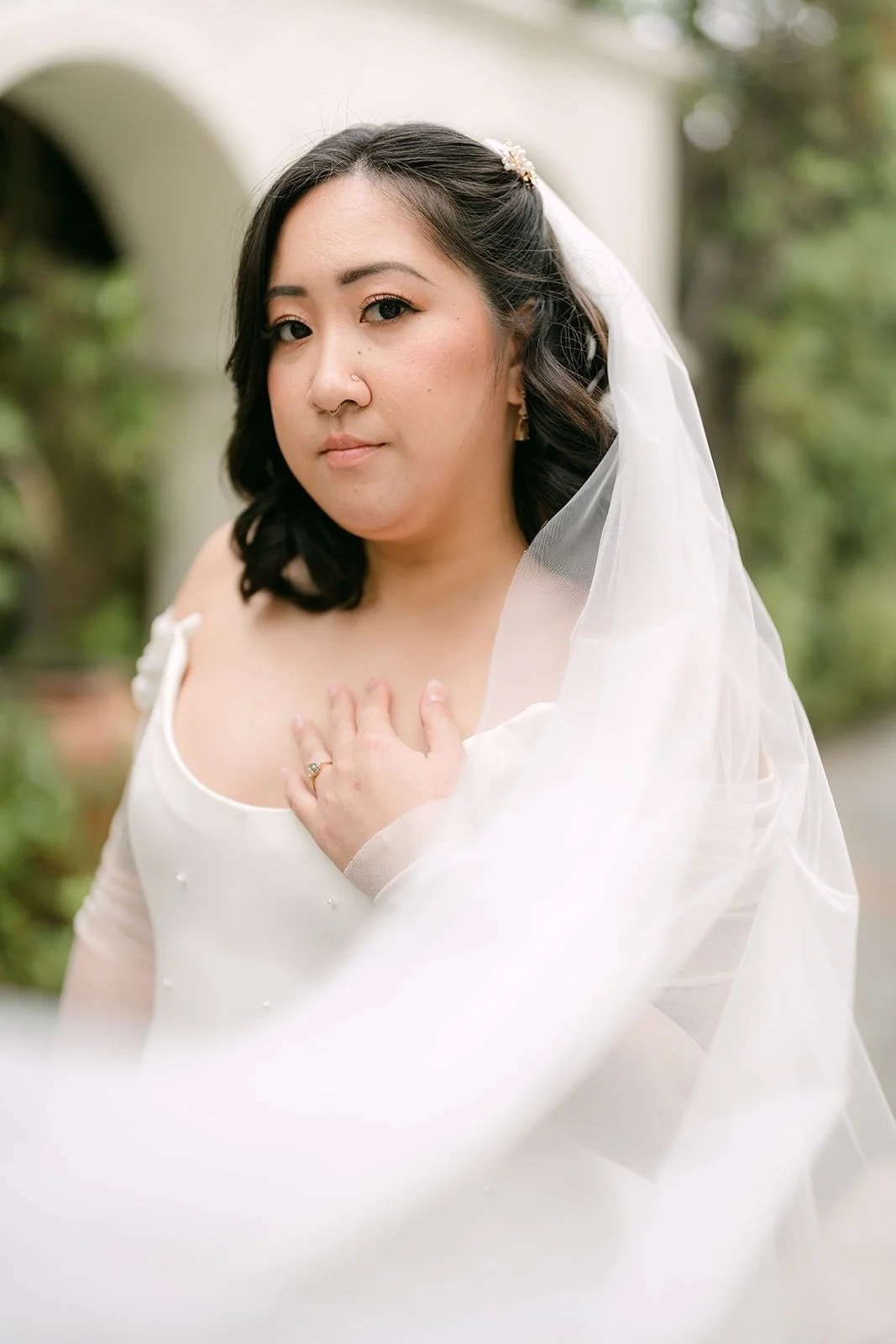 Close up of Vivian holding her veil