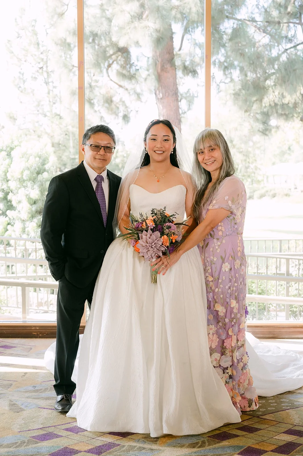 Angela with her parents before the ceremony