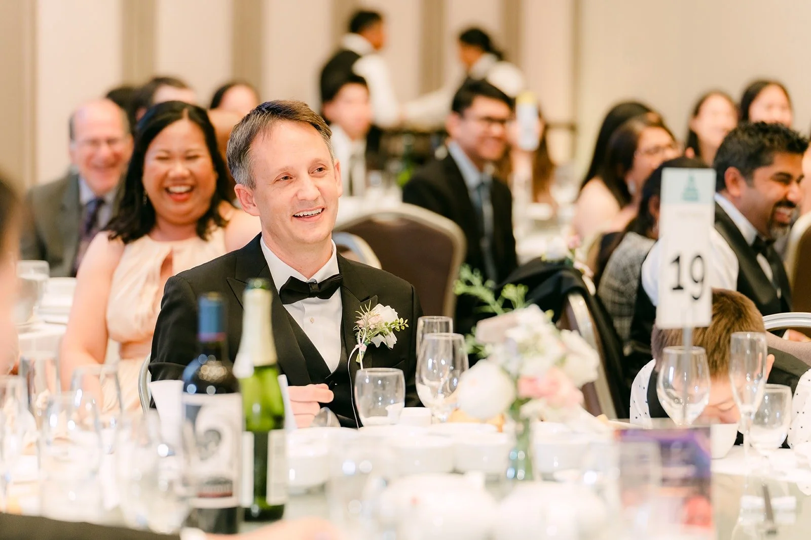 Guests laughing at their table during the speeches