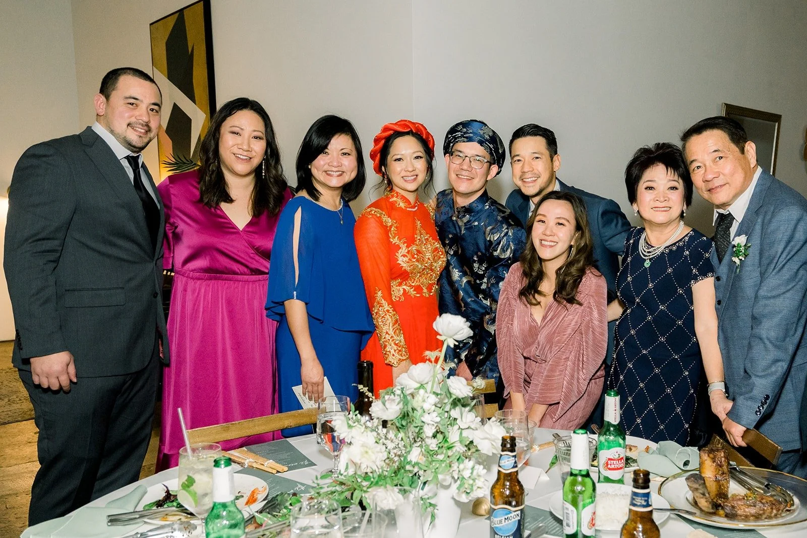 Cindy and Alex with guests at a table toast